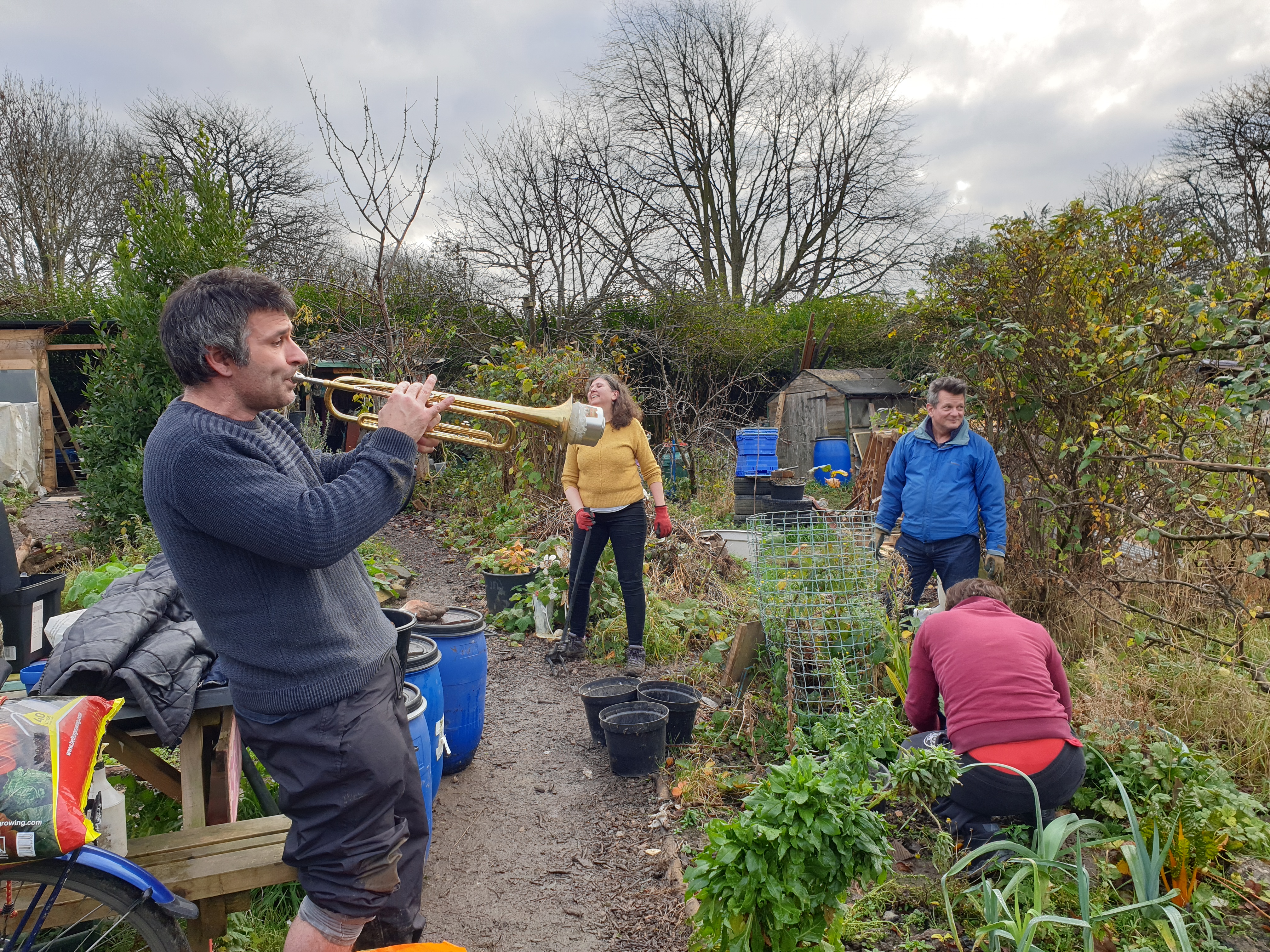 Man playing trumpet in allotments, Man About Town project ( Creative Frame CIC)