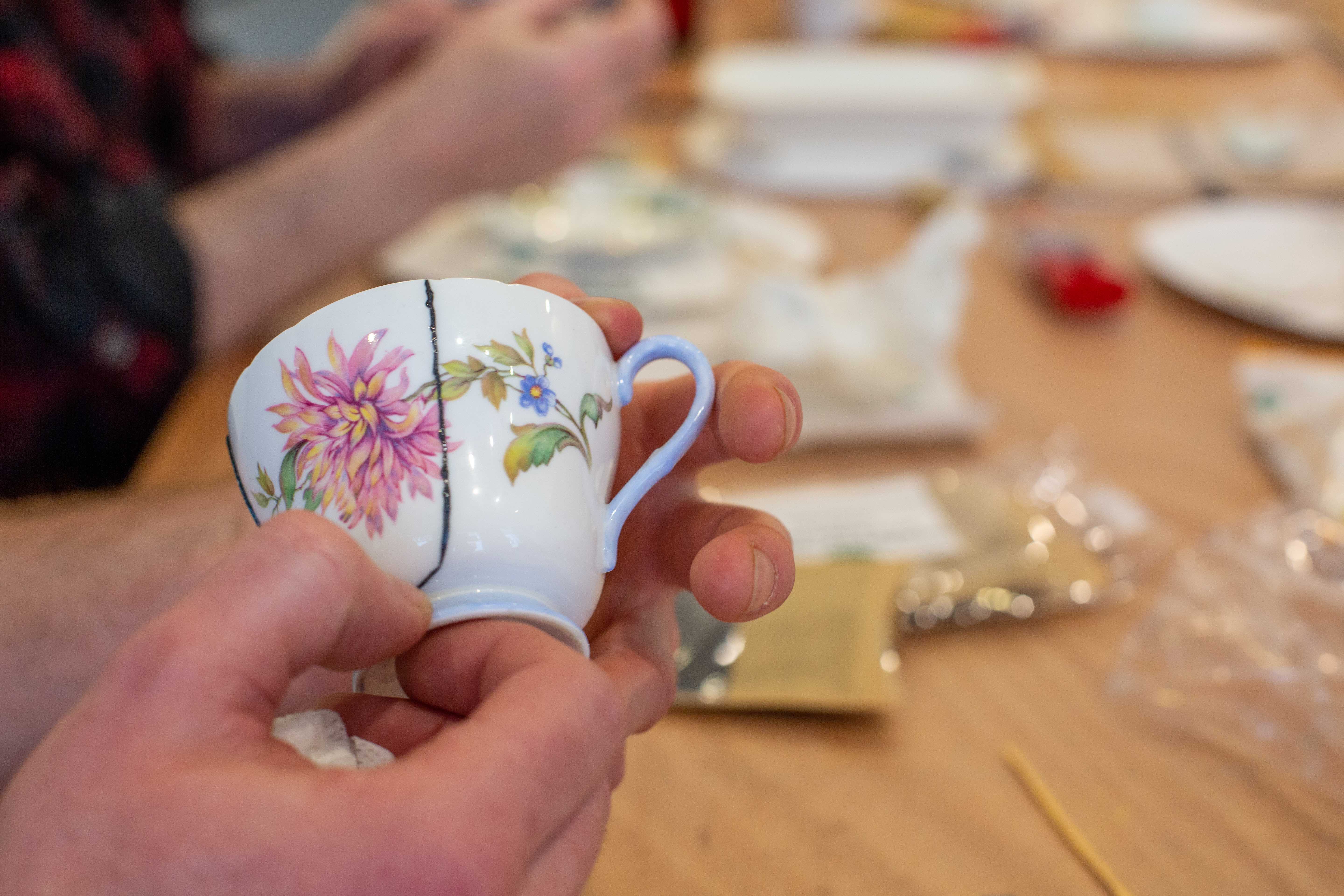 Small teacup being repaired as part of the Kintsugi workshop during The Repair Centre workshop, Portraits of Recovery 2022