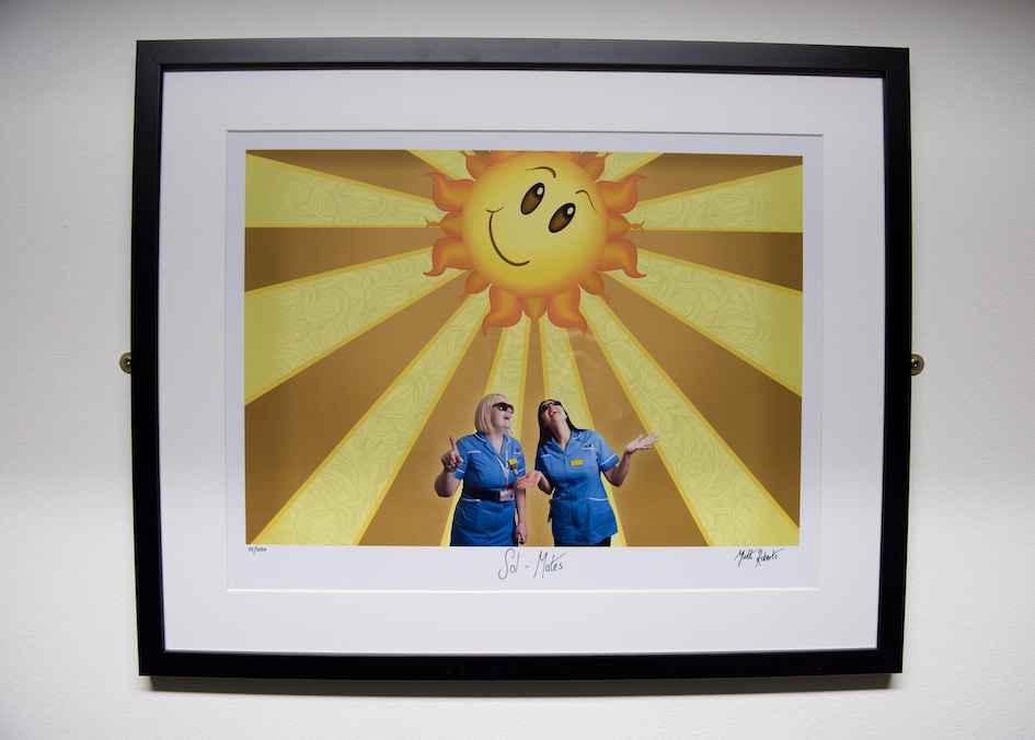 Image of two nurses with a cartoon sun behind them, by Matt Roberts, from Air Arts' Wellbeing in the Workplace exhibition