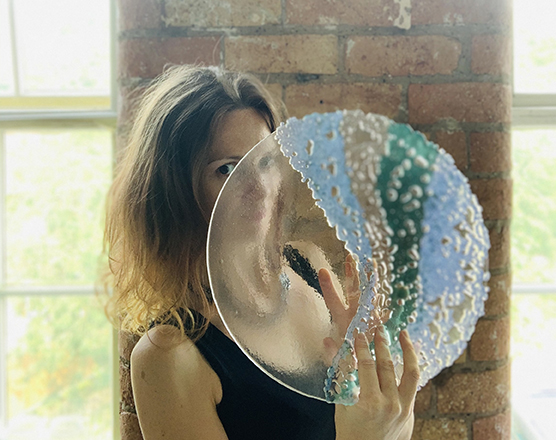 Stevie Davies holding one of her glass artworks