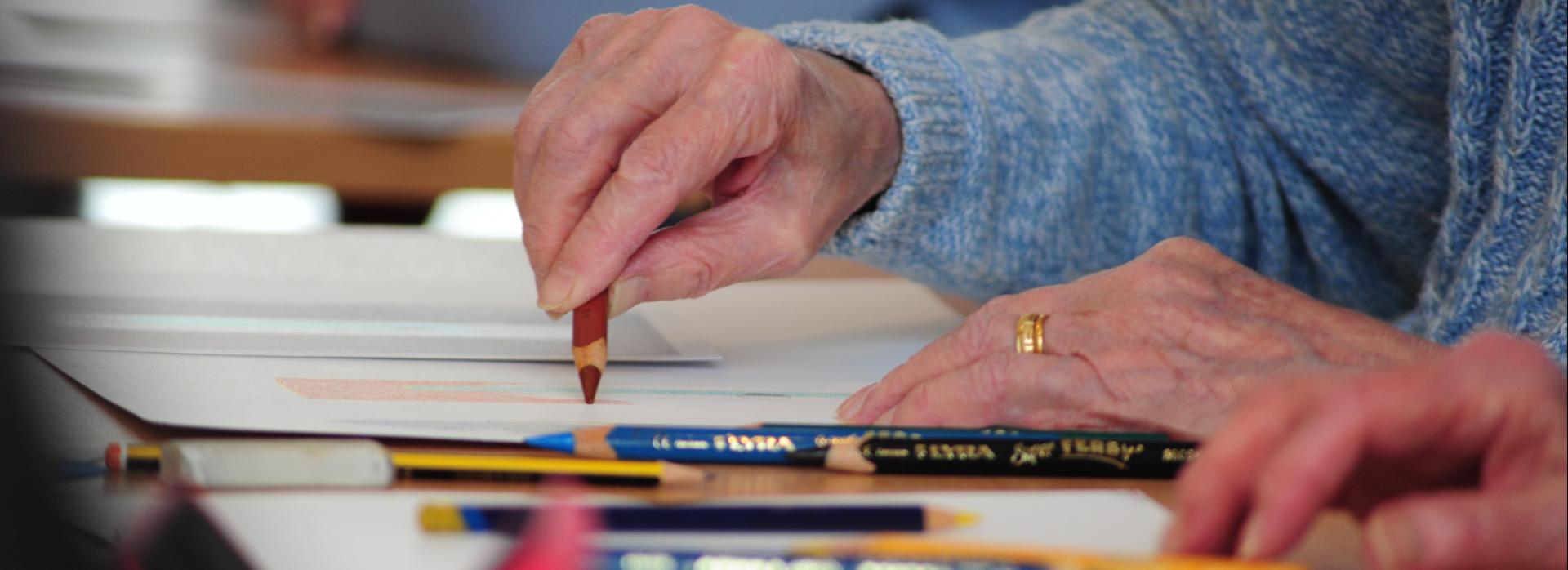 Close up Photo of a person drawing on a table as part of Creative Health CIC’s Still Lively Programme (Celebrating Age, ACE/Baring Foundation) 