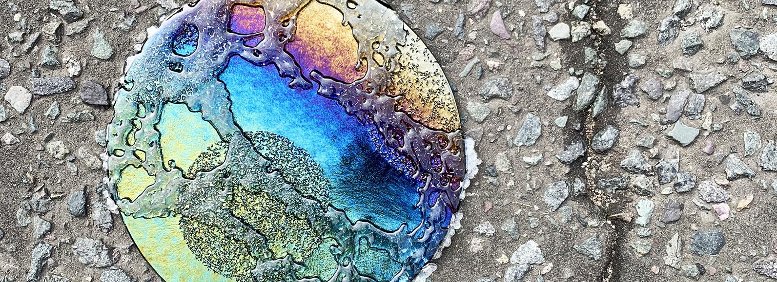 Stevie Davies Petrol Rainbow disc on concrete