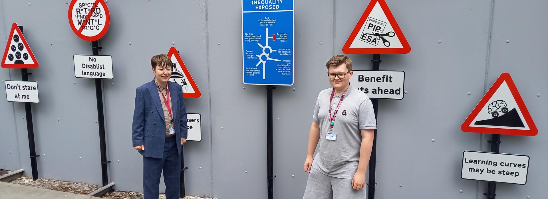 Theo & Bobby – members of Barnsley SEND Youth Forum and Barnsley Youth Council standing in front of The Way Ahead art installation created with disabled artist, Caroline Cardus