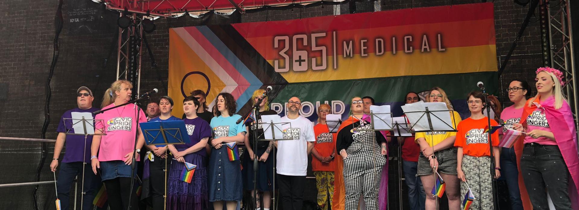 Group of people standing on a stage singing