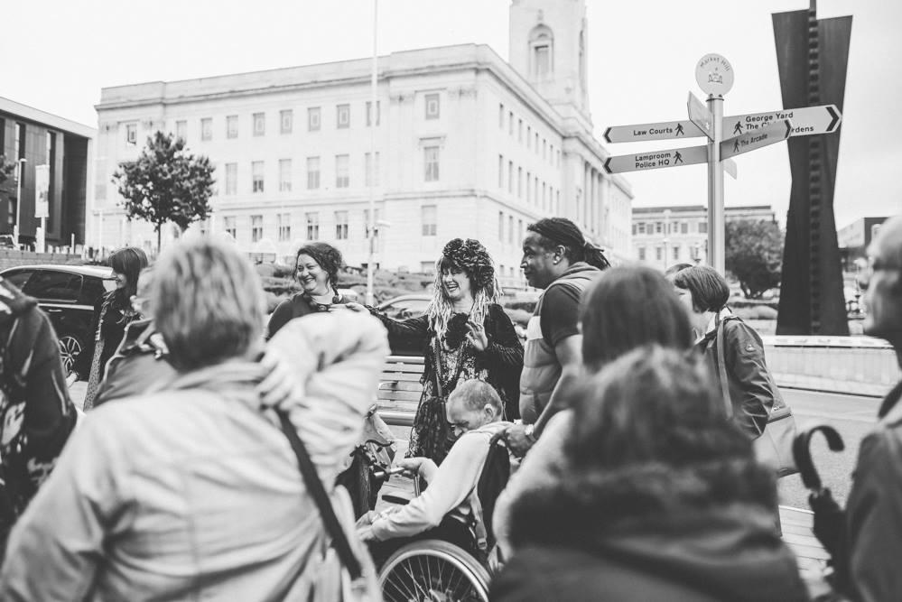 People taking part in the Spaces Between Walk (Creative Recovery) with Barnsley Town Hall in the background