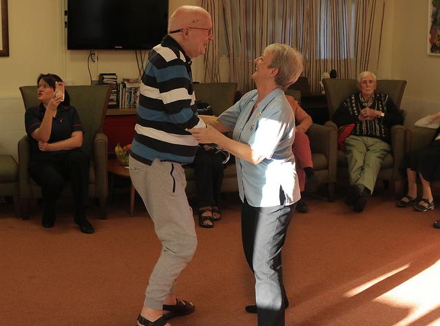 Two people dancing in a care home