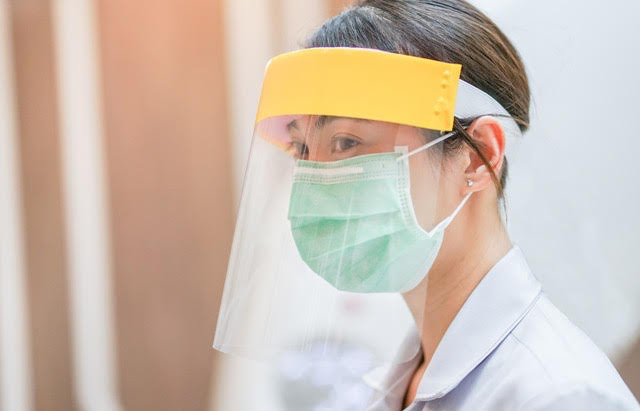 A nurse wearing personal protective equipment