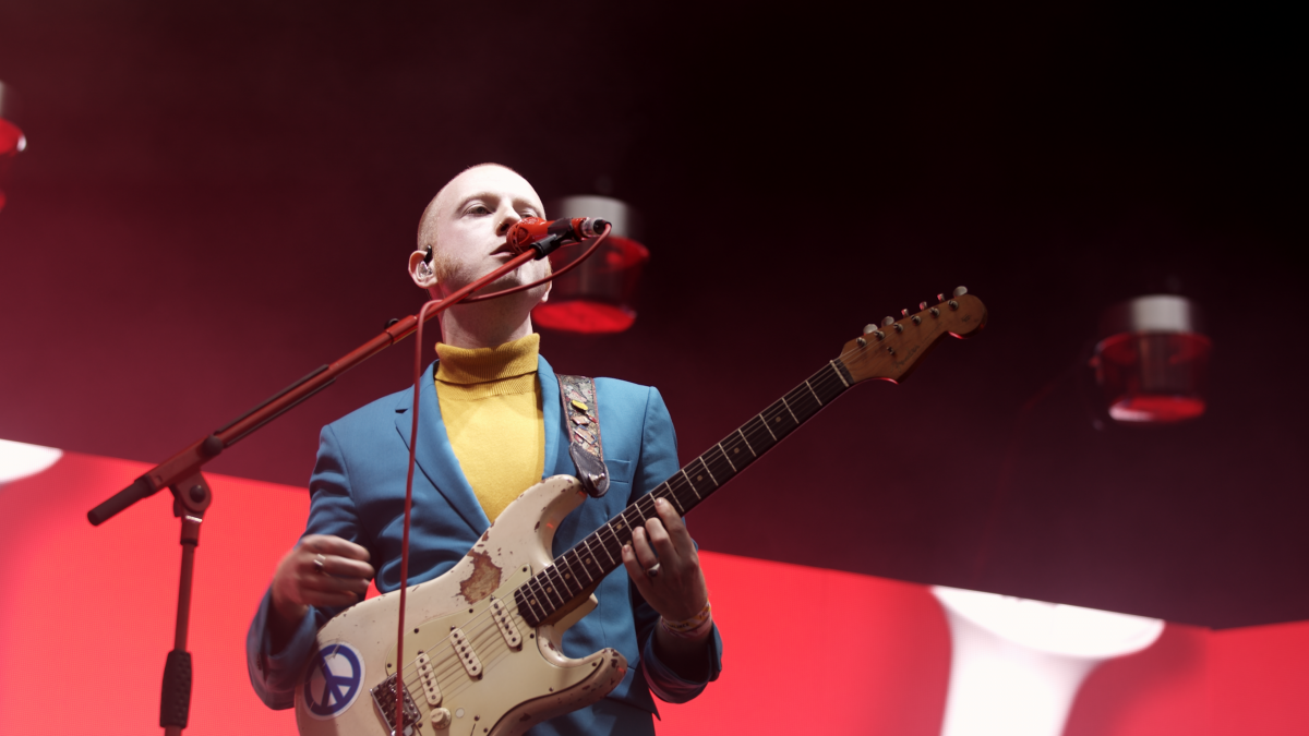 A photograph of a performer singing and holding a guitar at Tramlines 2019; Dan Bale, Open House Pictures