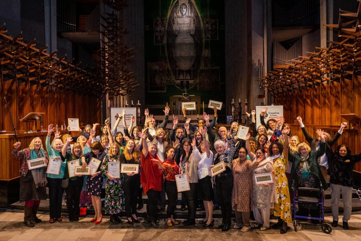 Creative Lives Awards 2020 and 2021 winners diverse group inside a cathedral celebrating