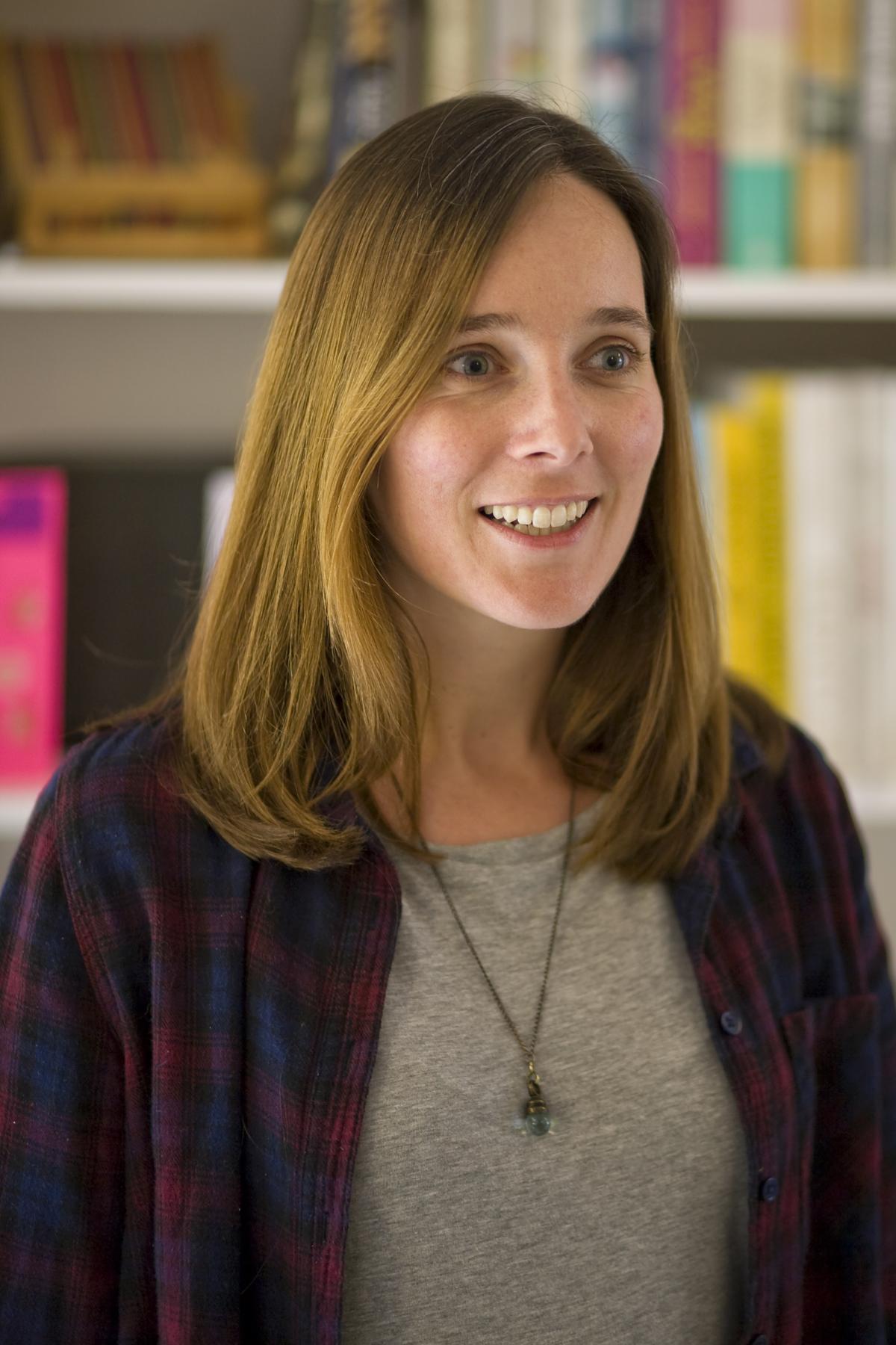 Hannah Dunster stood in front of a bookcase smiling