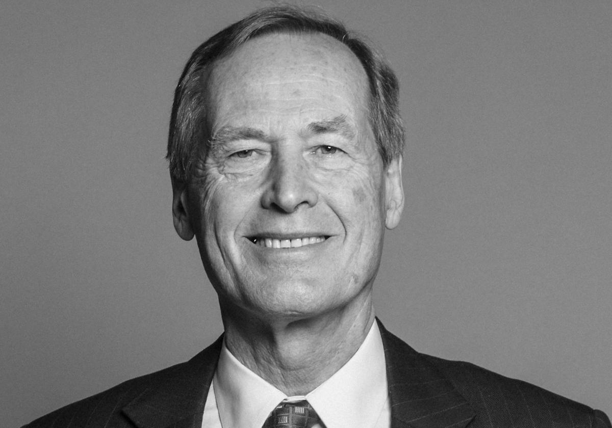 black and white head-and-shoulders photograph of a man looking straight at the camera and smiling