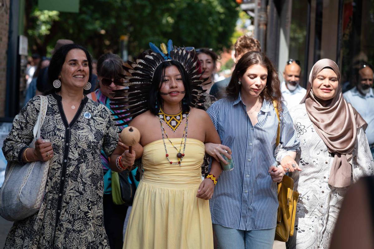 A group of women walking linking arms