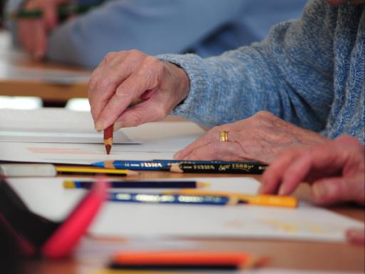 Close up Photo of a person drawing on a table as part of Creative Health CIC’s Still Lively Programme (Celebrating Age, ACE/Baring Foundation) 