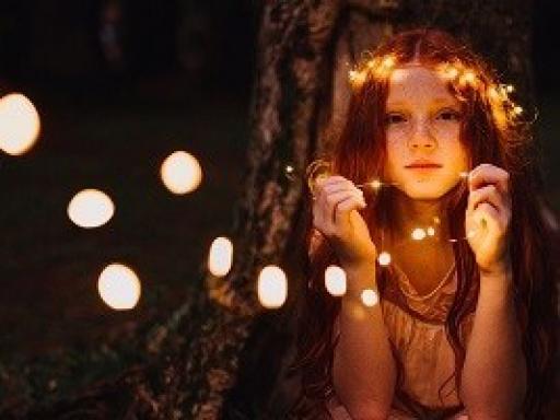 picture of a young woman with a string of lights