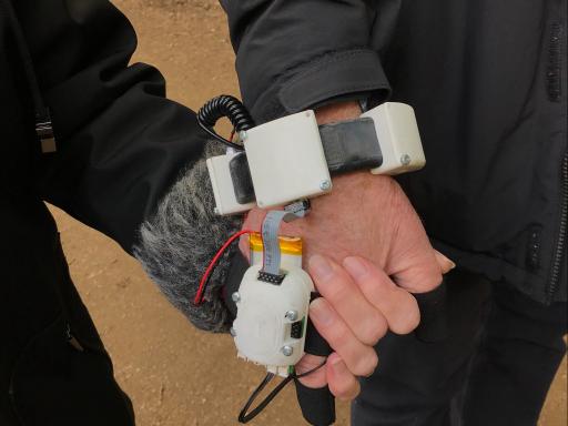 A picture of two hands holding - wearing technological 'gloves' created by Invisible Flock's Dementia Peer Support Group in Leeds