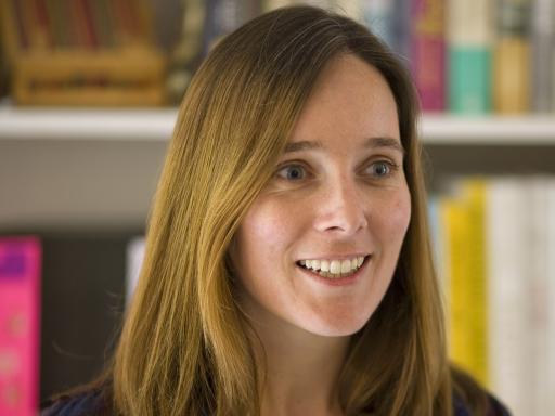 Hannah Dunster stood in front of a bookcase smiling