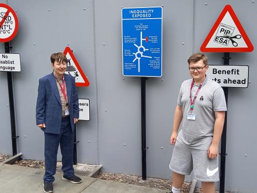 Theo & Bobby – members of Barnsley SEND Youth Forum and Barnsley Youth Council standing in front of The Way Ahead art installation created with disabled artist, Caroline Cardus