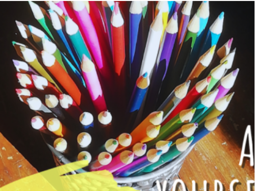 Coloured pencils in a pot on a wooden table