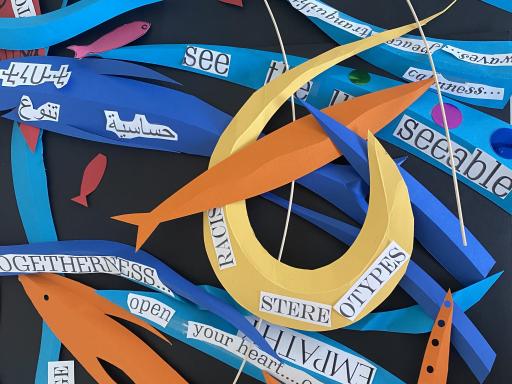 A pile of colourful paper shapes with cut out words and sentences