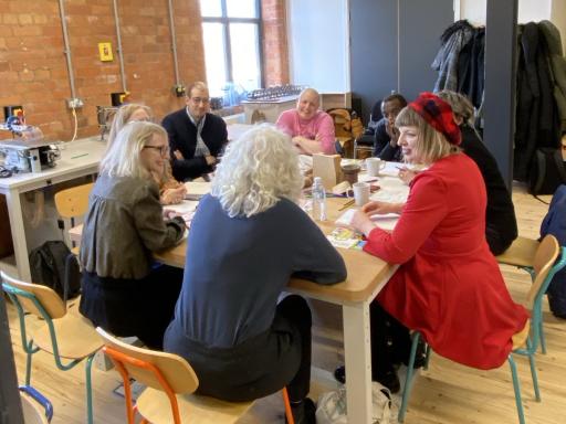 a group of people sit at a table talking